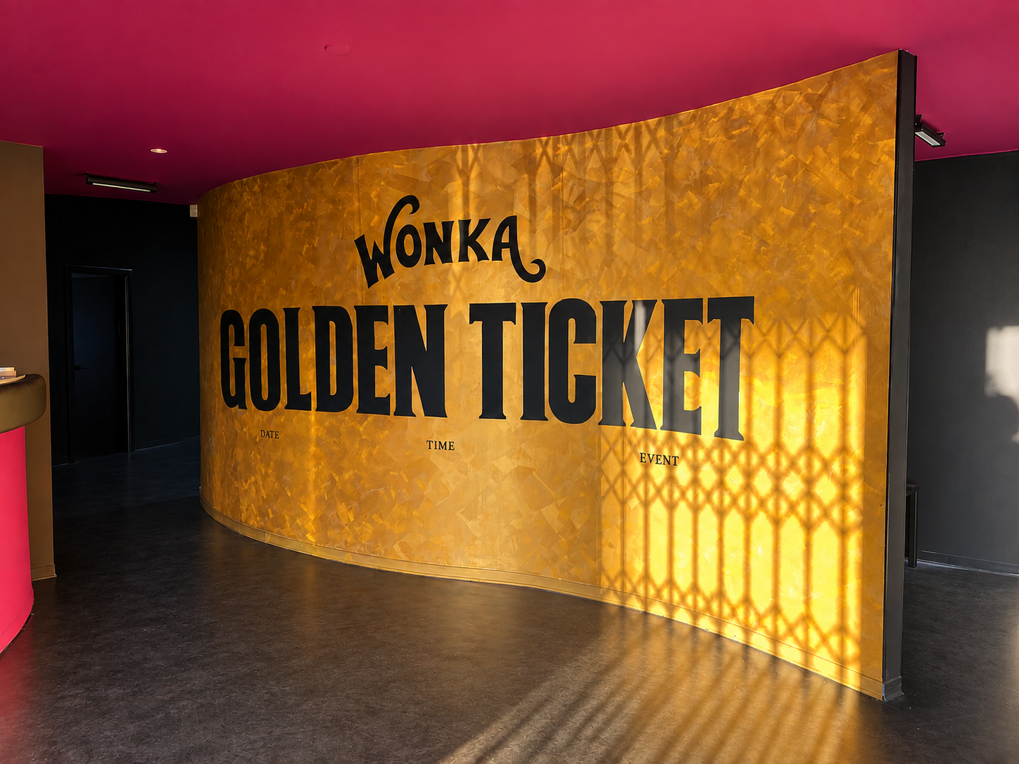Golden hand lettering painted on a dark wall
